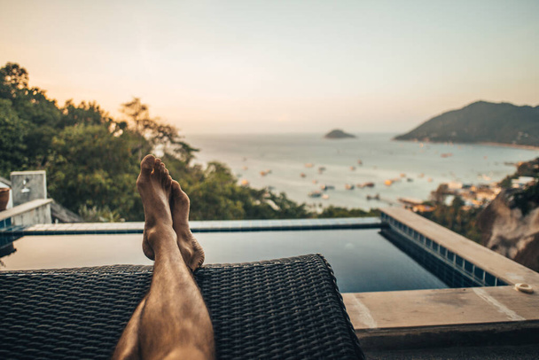 A man Chilling at home with a sunset and sea view in Thailand - Foto, Imagem