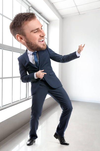 Funny dancing businessman with big head in office - Foto, immagini