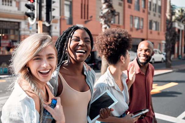 A Group of diverse students having fun outdoors in the city on a sunny summer day. Portrait of young people or friends laughing and smiling together in an urban town while walking to campus. - Foto, Imagem
