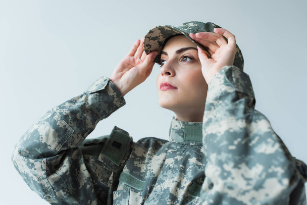 Soldier in military uniform wearing cap isolated on grey  - Фото, зображення