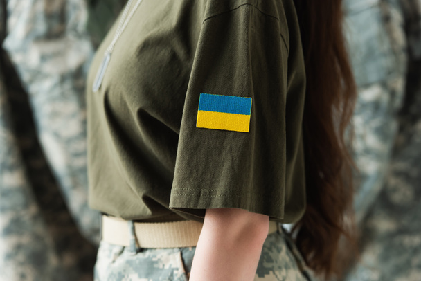 Cropped view of chevron with ukrainian flag on soldier uniform - Fotó, kép