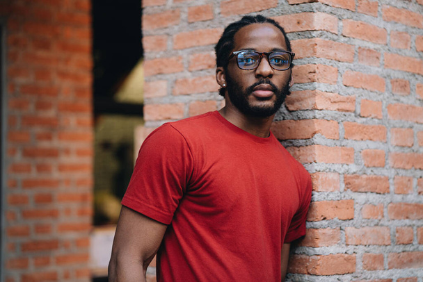 A portrait of young black man in red t-shirt and eyeglasses - Valokuva, kuva