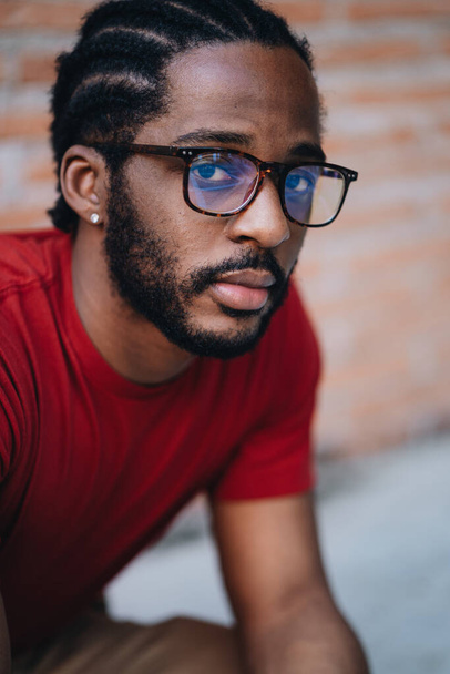A portrait of young black man in red t-shirt and eyeglasses - Photo, image