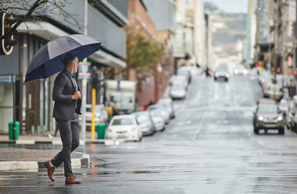 My city is beautiful on rainy days. a handsome businessman walking to work on a rainy day - Fotografie, Obrázek