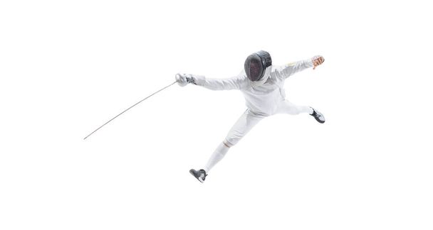 Aerial view of male fencer in fencing costume and mask holding smallsword and training isolated on white background. Athlete practicing in motion, action. Copyspace for ad. - Foto, afbeelding