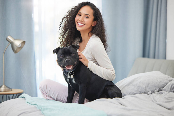 Appreciate life when you wake up in the morning. a young woman and her dog in bed at home - Фото, изображение