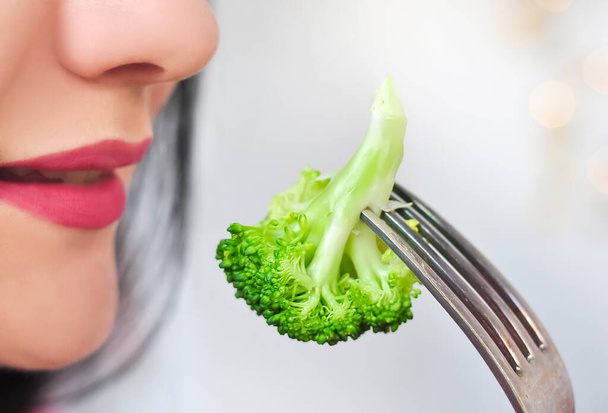 fork with green fresh vegetarian broccoli for dieting, low calorie food. High quality photo - Fotó, kép