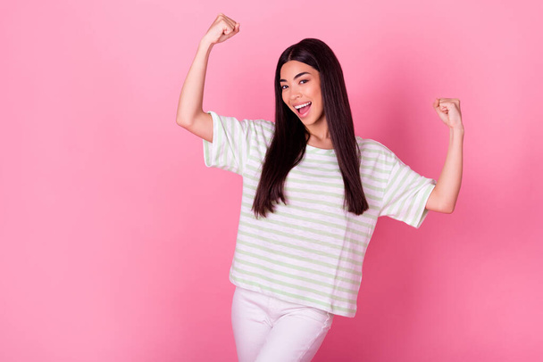 Photo of delighted astonished indonesian girl raise fists accomplishment isolated on pink color background. - Fotografie, Obrázek