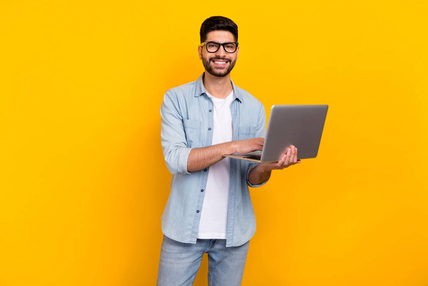 Photo of confident handsome hispanic man enjoy working from home dressed trendy jeans outfit spectacles isolated on yellow color background. - Foto, Bild