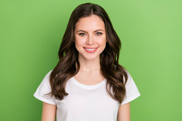 Photo of adorable cute young lady wear white t-shirt smiling isolated green color background. - Фото, зображення