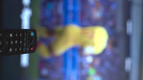 vertical video remote control changing different football matches channels . High quality 4k footage - Séquence, vidéo