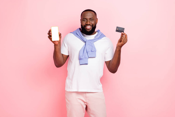 Photo of young stylish wealthy man use wireless transactions to buy online shop isolated on pink color background. - Foto, Imagem