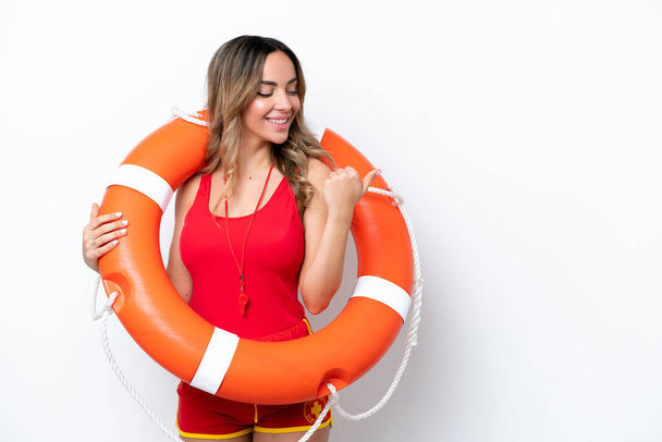 Lifeguard caucasian woman isolated on white background pointing to the side to present a product - Foto, Bild