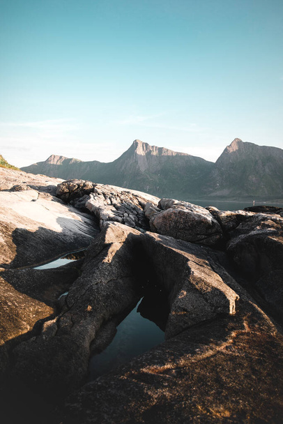 A rocky mountain with a lake in the sun - Zdjęcie, obraz