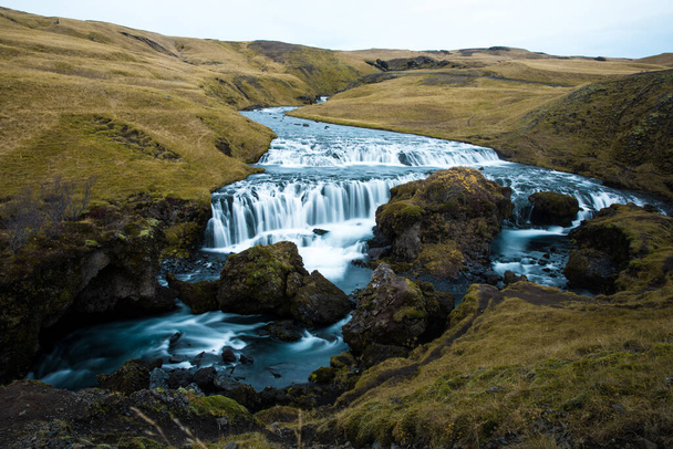 A scenic view of the Skogafoss waterfall on the Skoga River against blue sky on a sunny day in South Iceland - Foto, Bild