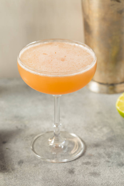 Boozy Refreshing Allspice Bourbon Lions Tail Cocktail in a Coupe - Fotó, kép