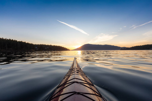 Sea Kayak paddling in the Pacific Ocean. Colorful Sunset Sky. Taken near Victoria, Vancouver Islands, British Columbia, Canada. Concept: Sport, Adventure - Fotoğraf, Görsel