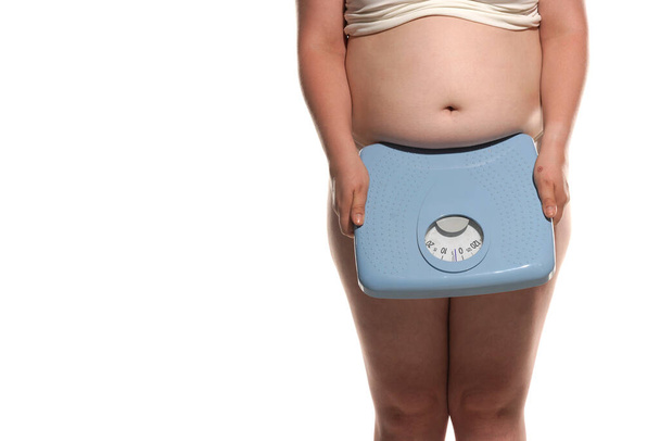 Big fat woman carrying large old bathroom scale. - 写真・画像