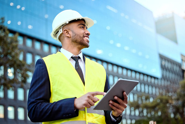 Get your metrics right. a young businessman on a construction site using a digital tablet - Fotó, kép