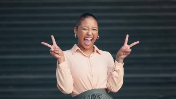 Happy, excited and smiling young woman posing with a peace hand pose. Cheerful female portrait of a positive person having a fun time. Carefree lady with healthy teeth feeling playful - Filmagem, Vídeo