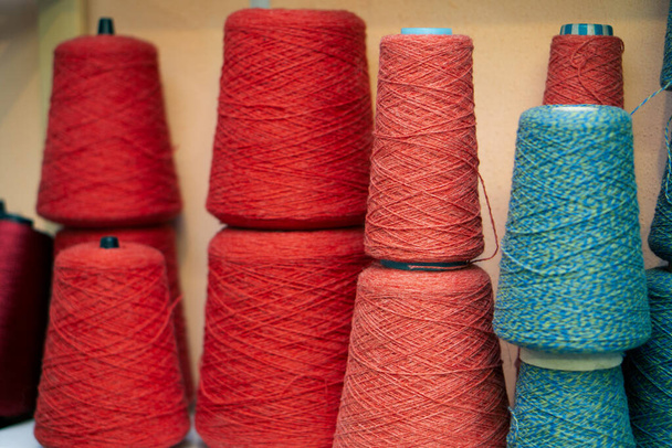 Multi-colored bobbins of yarn on a light background.  - Zdjęcie, obraz