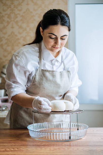 Confectioner small business, sugar confections, sweet confection local business. Asian Arabic confectioner chef make heart shape Mirror Glaze mousse cake - Fotó, kép