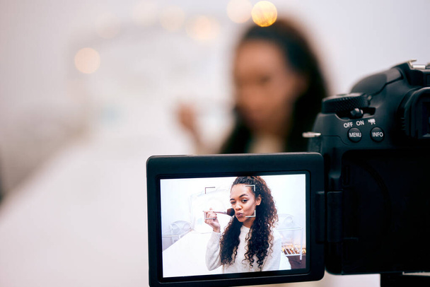 Follow me for more makeup tutorials. a young woman doing her makeup while recording a video for her blog - Foto, Imagem