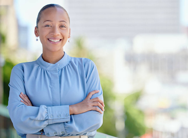 Happy, confident and smiling business woman standing with arms crossed outside at work alone. Portrait of the face of one cheerful, joyful and proud female corporate professional with arms folded. - Fotoğraf, Görsel