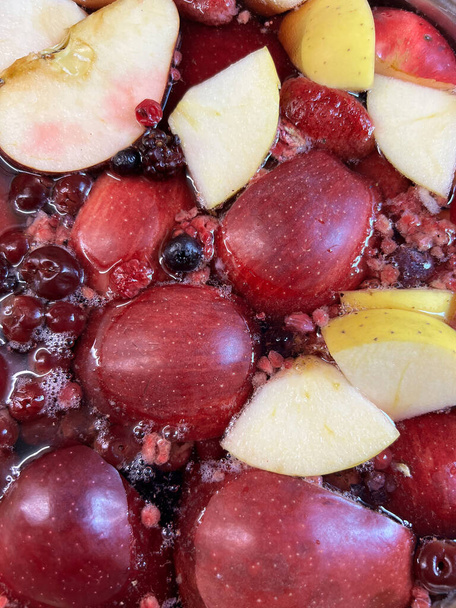 Compote of pomegranates, apples and cherries. Close-up. High quality photo - Foto, afbeelding