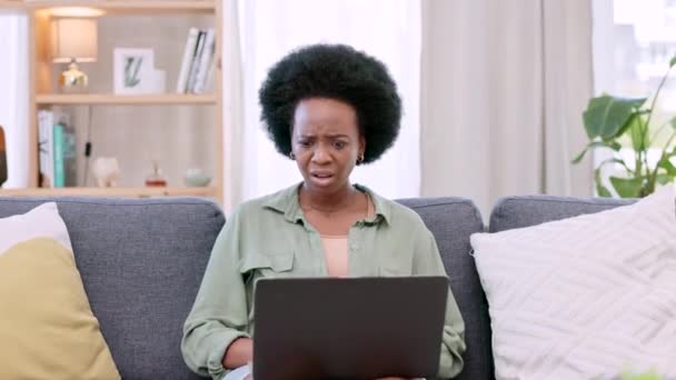 Angry, unhappy and frustrated woman checking laptop for salary, earnings and pay in home living room. Portrait of sulking, grumpy and sad afro lady feeling impatient while waiting for trading profit. - 映像、動画