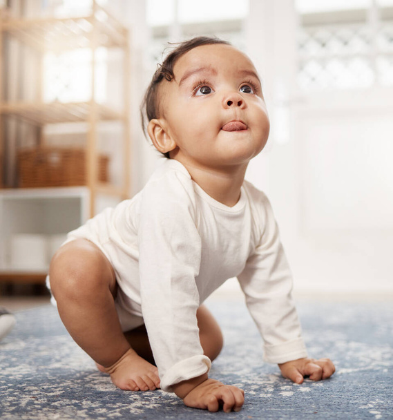 When I see something I want, I go for it. an adorable baby girl sitting on the floor at home - Foto, Imagem
