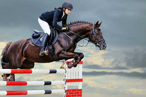 Equestrianism: Young girl in jumping show - Photo, Image