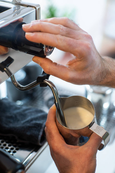 A closeup shot of A Bartender's hand preparing a coffee cup from a coffee machine - Photo, Image