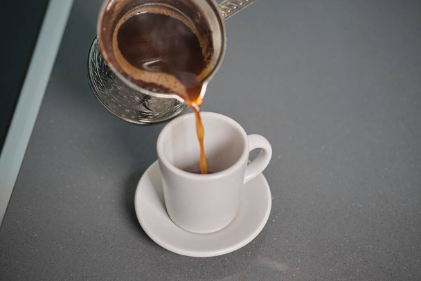 A selective focus shot of Traditional Turkish Coffee made with Cezve - Φωτογραφία, εικόνα