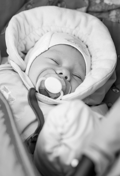 Nouveau-né avec une sucette couchée dans une poussette
 - Photo, image