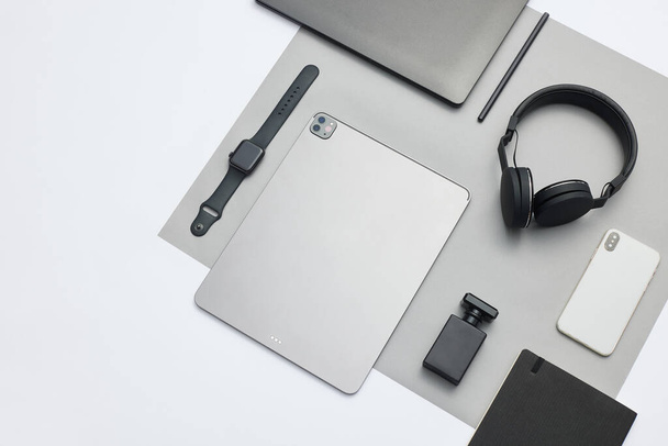 A flat lay of electronic products on a white background - Fotó, kép