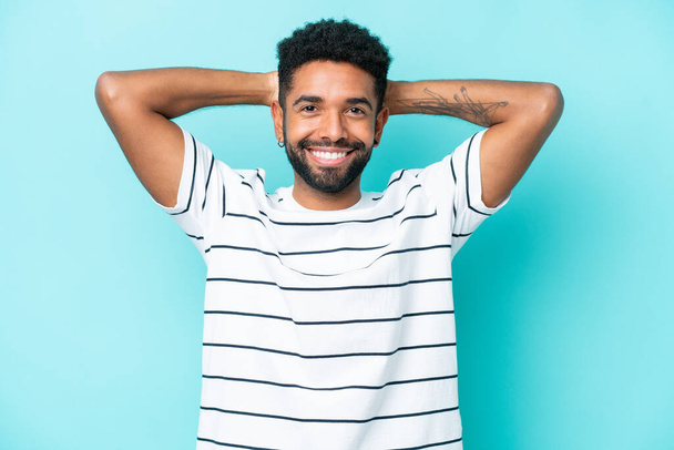 Young Brazilian man isolated on blue background laughing - Foto, Imagen
