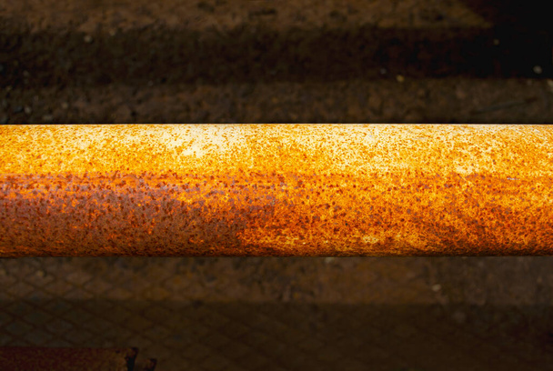 Gas Rusty steel pipe, Steel pipes are placed in the factory, steel pipe for manufacturing. Old yellow pipe on a dark background - Valokuva, kuva