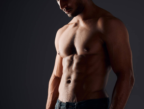 Come a little closer. an unrecognizable man standing alone in the studio and posing shirtless - Photo, image