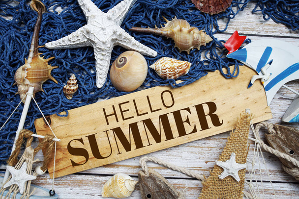 Hello Summer text message decoration with seashell and marine on wooden background - Фото, изображение