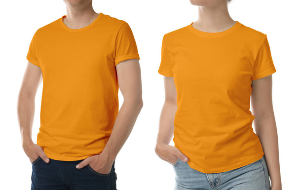 Man and woman wearing orange t-shirts on white background, closeup. Mockup for design - Fotografie, Obrázek