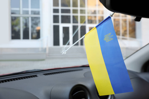 National flag of Ukraine on windshield inside car - Fotó, kép