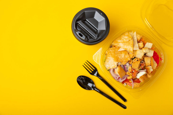Poke from salmon, funchose, vegetables and pita crispy on a yellow-orange background.Healthy healthy food.Hawaiian food. View from above. Place to copy. - 写真・画像
