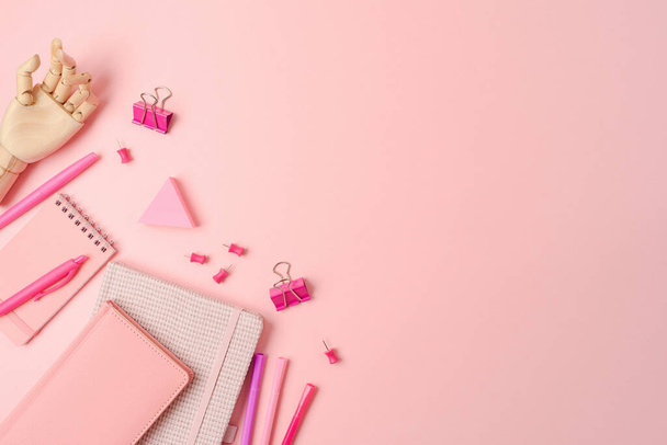 Feminine pink desk with notebook and stationery. Background for back to school concept. Top view, flat lay - Foto, afbeelding