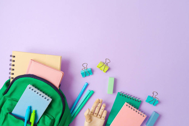 Back to school  concept with green backpack and school supplies on purple background. Top view, flat lay - Fotoğraf, Görsel