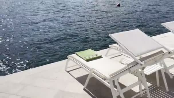 Sun loungers stand on the banks of Perast near the water. High quality 4k footage - Video