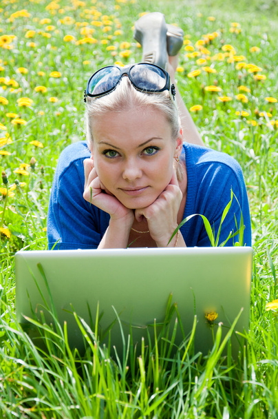 A girl student with a laptop in the park - Photo, image