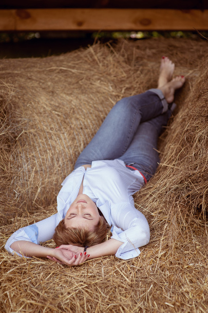 Woman over haystack in barn - Photo, Image