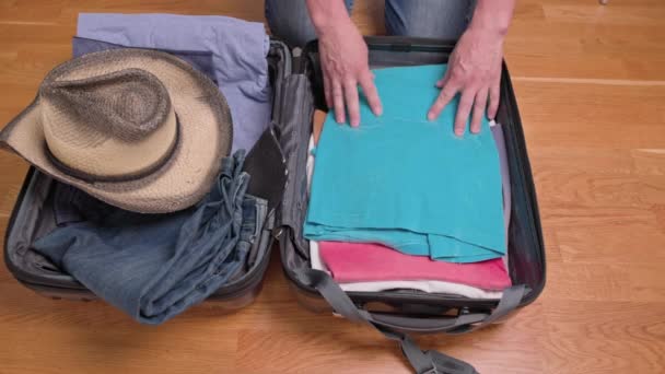 Close-up zicht van de man die kleding inpakt in een koffer voor toeristische reis. Zweden. - Video