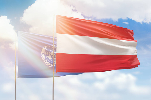 Sunny blue sky and flags of austria and united nations - Φωτογραφία, εικόνα
